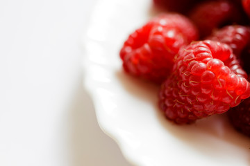 Raspberries in a white plate