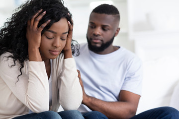 Loving african man soothing upset girlfriend, apologizing after quarrel - obrazy, fototapety, plakaty
