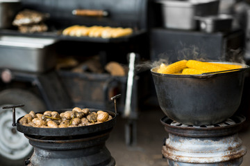 Different grilled food in cast iron bowls freshly cooked