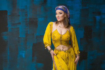 Beautiful woman arabian turkish oriental in carnival yellow costume