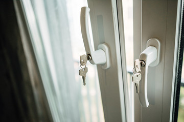 Naklejka premium key in the handle of plastic window