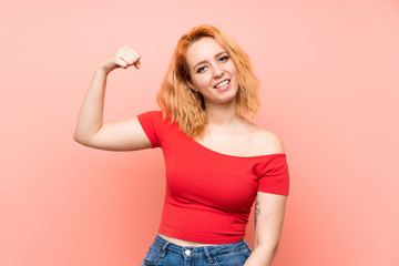 Young woman over isolated pink background doing strong gesture