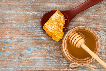 Honey background. Fresh honey in the pot with honeycombs