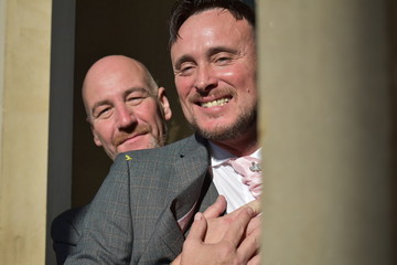 Portrait of a loving gay male couple on their wedding day.