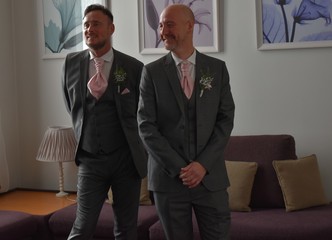Portrait of a loving gay male couple on their wedding day.
