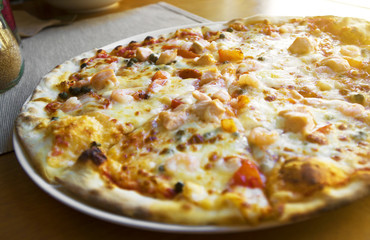 Pizza with seafood. Mozzarella, tuna and shrimps.
