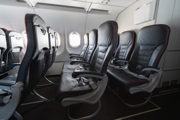 Airplane seats and windows. Economy class comfortable seats without passengers. New low-cost...