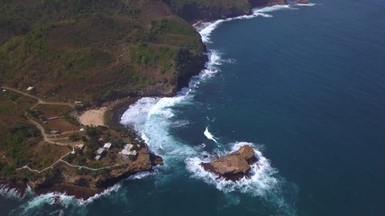 Aerial: Drone flying near suspension bridge , attraction on Timang beach, Java island, Indonesia