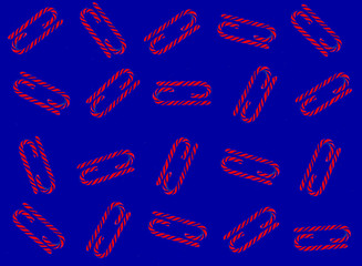 Christmas candy cane pattern on blue background. Flat lay and top view