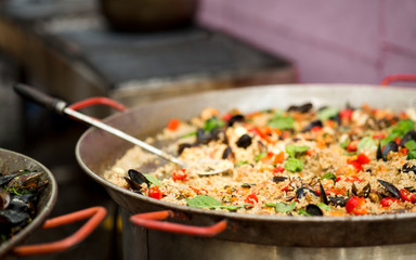 Tasty and juicy pilaf with mediterranean mussels in bowl outdoor