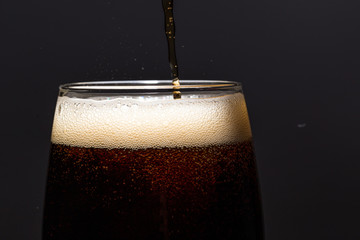drink in a glass on a black background