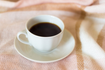 a Cup of coffee on the background of a warm blanket
