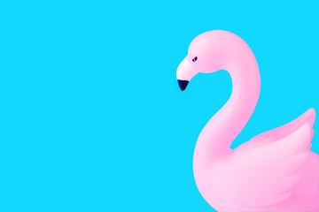 Inflatable Flamingo on a blue background, trendy summer concept, banner background with copy space.