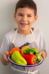 little boy with fresh vegetables