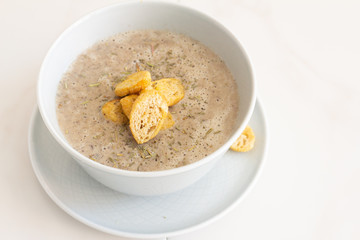 mushroom soup with croutons in a plate
