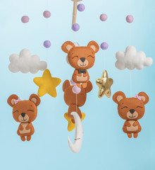 Colorful and eco-friendly children's mobile from felt. On blue background.