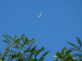 A passenger plane flying in the blue sky