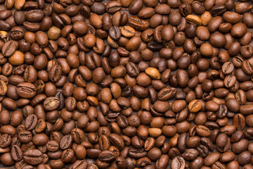 Roasted coffee beans background. Top view. Space for text.