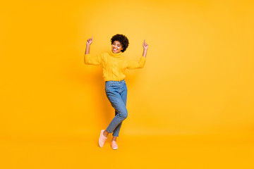 Fototapeta na wymiar Full length body size photo of curly crazy funny overjoyed girlfriend dancing rejoicing wearing jeans denim sweater footwear isolated over yellow background vivid color