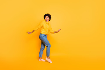 Fototapeta na wymiar Full length body size view of nice attractive charming lovely cheerful cheery funky wavy-haired girl having fun time isolated over bright vivid shine vibrant yellow color background