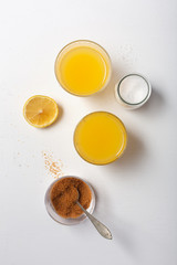 Fototapeta na wymiar Homemade Isotonic Energy Drink and Ingredients. Glasses With Yellow Liquid, Homemade Sport Beverage