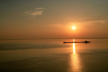 Dawn early in morning over wide long Volga river