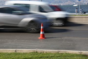Work on road. Construction cones. Traffic cone, with white and orange stripes on asphalt. Street and traffic signs for signaling. Road maintenance, under construction sign and traffic cones on road