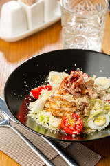 Meat salad with cheese and eggs close-up, food