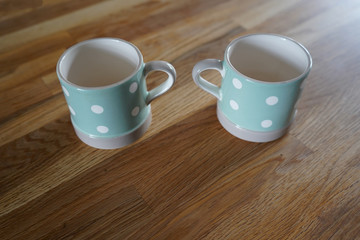 Two cups on a wooden surface