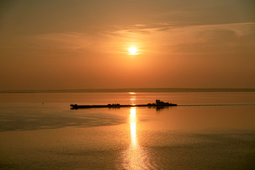 Fototapeta na wymiar Dawn early in morning over wide long Volga river