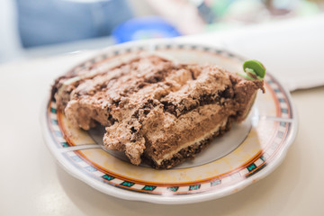 Fototapeta na wymiar Chocolate cake piece on plate at birthday party