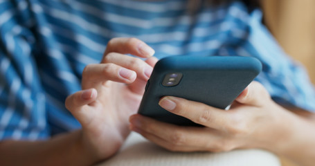 Woman use of mobile phone online at home