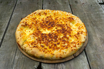 Traditional Georgian food khachapuri on the wooden table