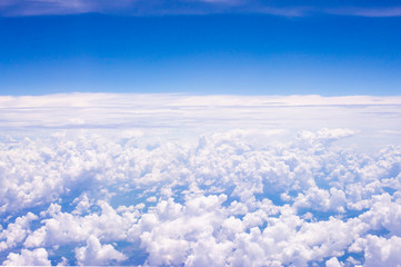 Fluffy white clouds on a blue sky background