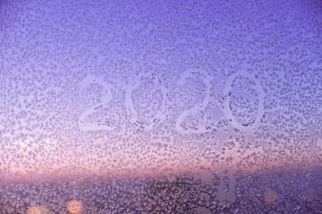 Winter texture of new year 2020. Color texture on glass from cold air from frost.