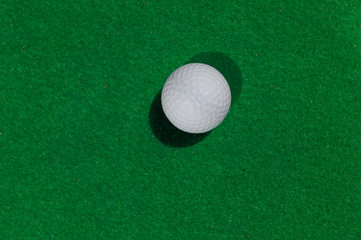 golf ball on green background top view