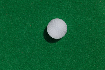 golf ball on green background top view
