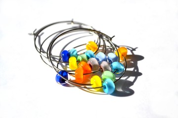 Fototapeta na wymiar Colorful hoop earrings with handmade lampwork beads.