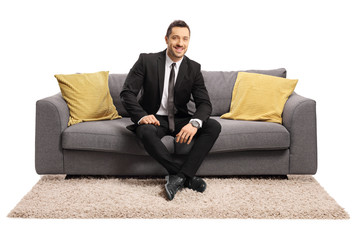 Businessman sitting on a sofa and smiling