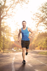Young fit man running outdoors