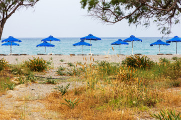 Beautiful beach, sandy beach and umbrella near the sea, summer vacation and travel concept, copy space.