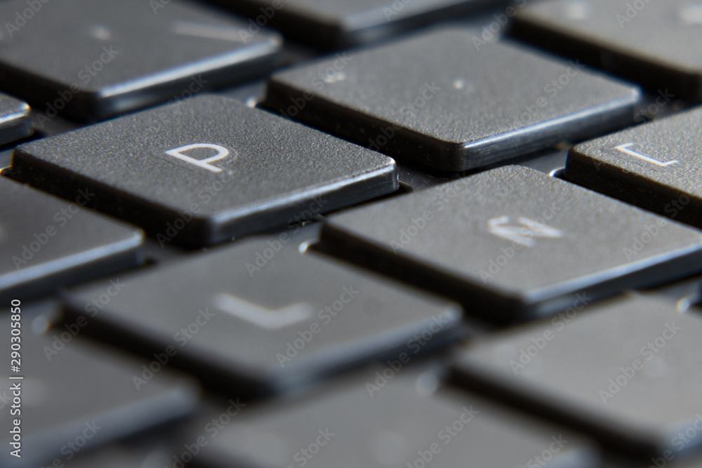 Poster black laptop keyboard. image in escape of keys with a fixed point and out of focus.