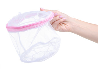 Pink laundry bag for underwear in hand on white background isolation