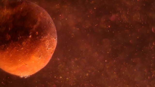 Cropped big planet rotating around its axis, sun shining its side, stars glittering, space dust is raising up.