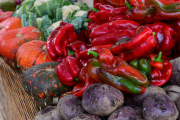 farmers market  different types of pumpkins, zucchini, red pepper, cabbage.  organic vegetables new harvest, market in Italy Tuscany Florence, vegan food , pumpkins halloween. selective focus