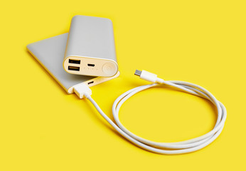 Power bank for charging mobile devices. White smart phone charger with power bank. Battery bank on...