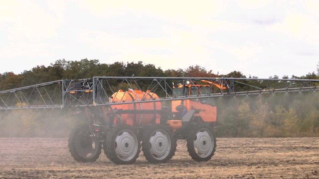 Tractor And Fertilizer Spreading Lime On Soil To Increase The Soils Fertility