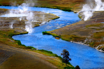 Fototapeta na wymiar River Flowing with Steam Rising in Yellowstone
