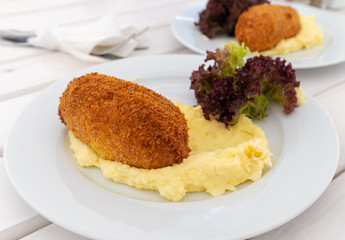 The Breaded cutlet with a mashed potatoes