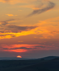 Summer sunset over distant mountains 